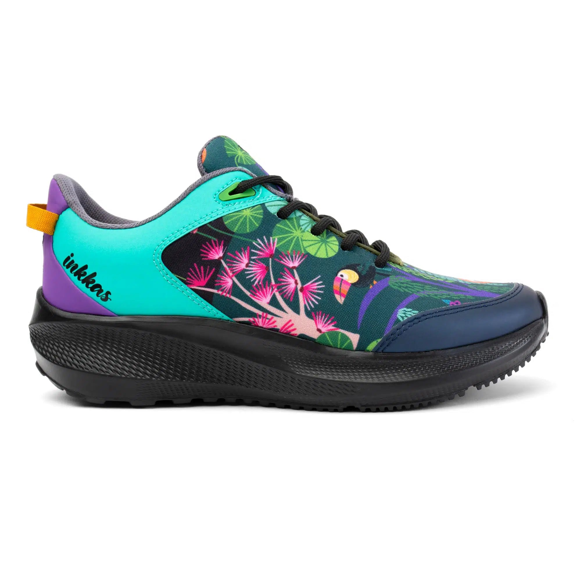 A colorful athletic sneaker by Inkkas, featuring a tropical design with a toucan, pink flowers, and green leaves on a black background. The shoe has a bright turquoise toe box, purple heel tab, and a thick black sole, shown against a plain white background.