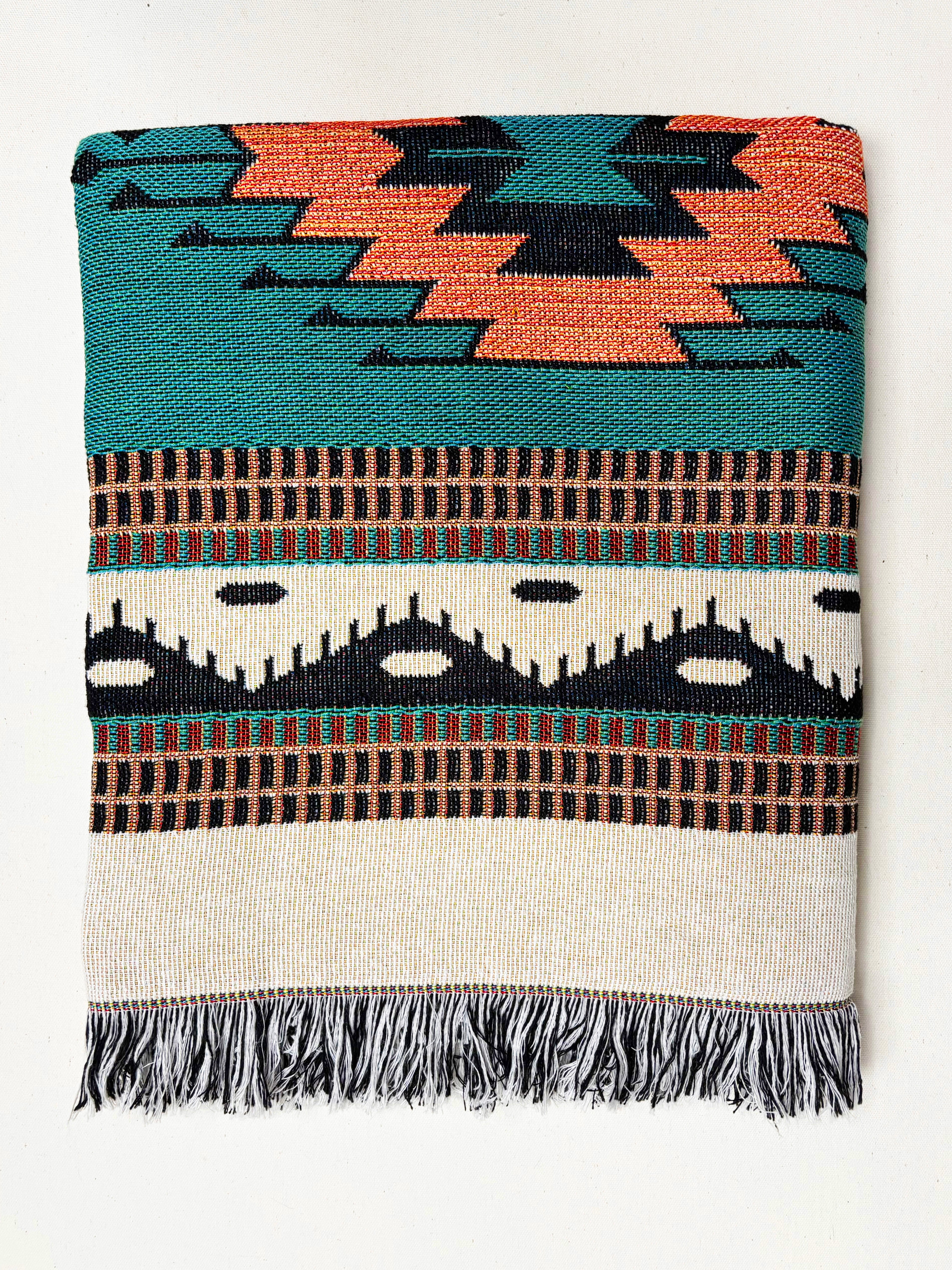 Woven blanket with geometric pattern on a white background