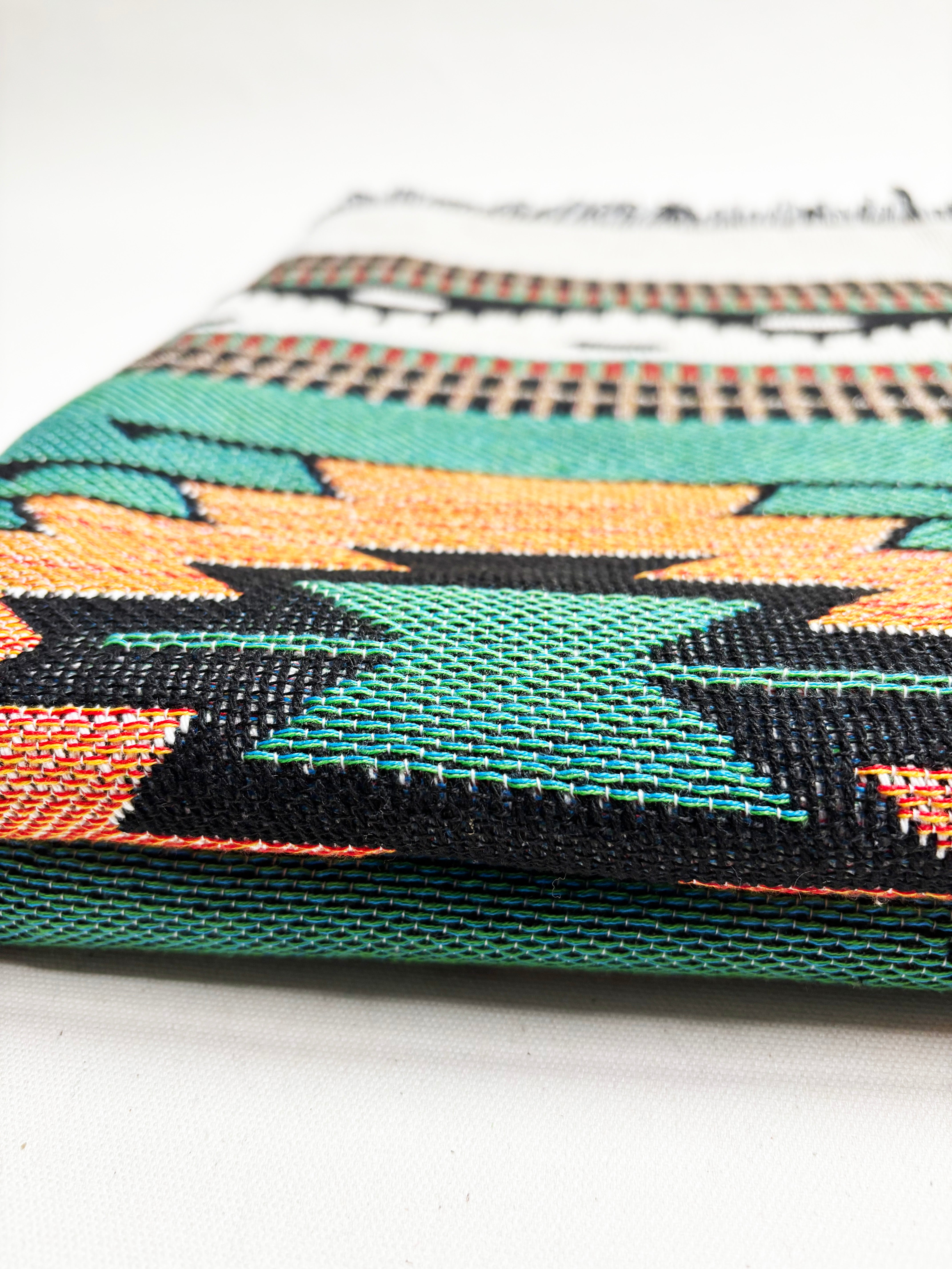 Close-up of a woven fabric with geometric pattern on a white background