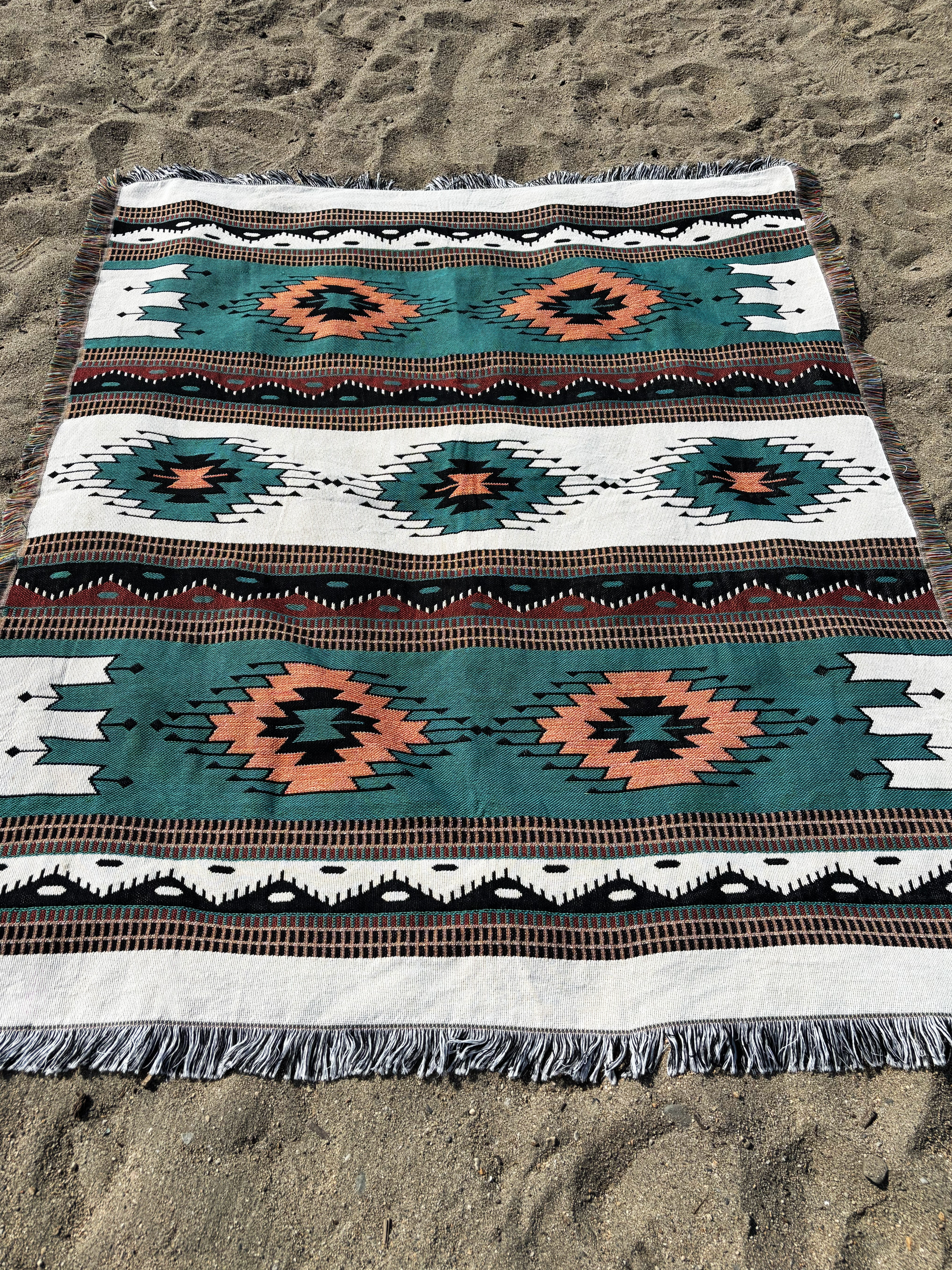 Patterned rug on a sandy surface