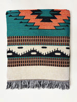 Woven blanket with geometric pattern on a white background