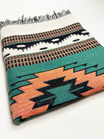 Woven blanket with geometric pattern on a white background