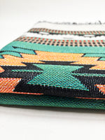 Close-up of a woven fabric with geometric pattern on a white background