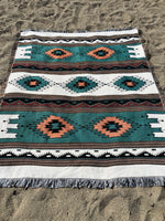 Patterned rug on a sandy surface