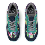 A pair of low-top sneakers shown from a top-down view on a white background. The shoes feature a dark navy suede base with green suede overlays, gray laces, and a colorful, busy floral and botanical print on the sides.