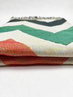 Stack of colorful fabric swatches on a white background